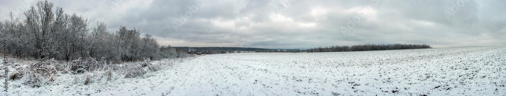 A panorama of a snow-covered field, providing humanity with food products. Agricultural crops under the snow A panorama of a snow-covered field, providing humanity with food products. Agricultural crops under the snow