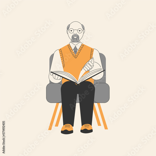 Elderly man reading a book while sitting in a chair