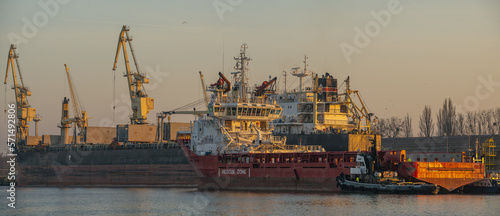 Merchant ship being repaired at the dock of a ship repair yard