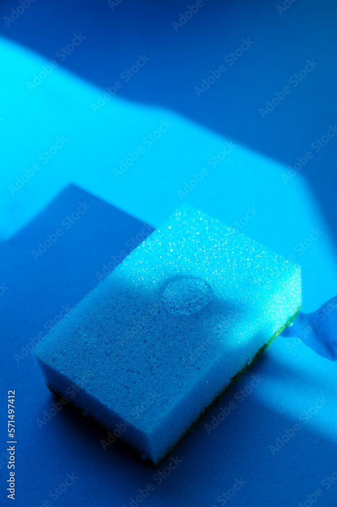blue dish sponge and blue background blue dish sponge and blue background