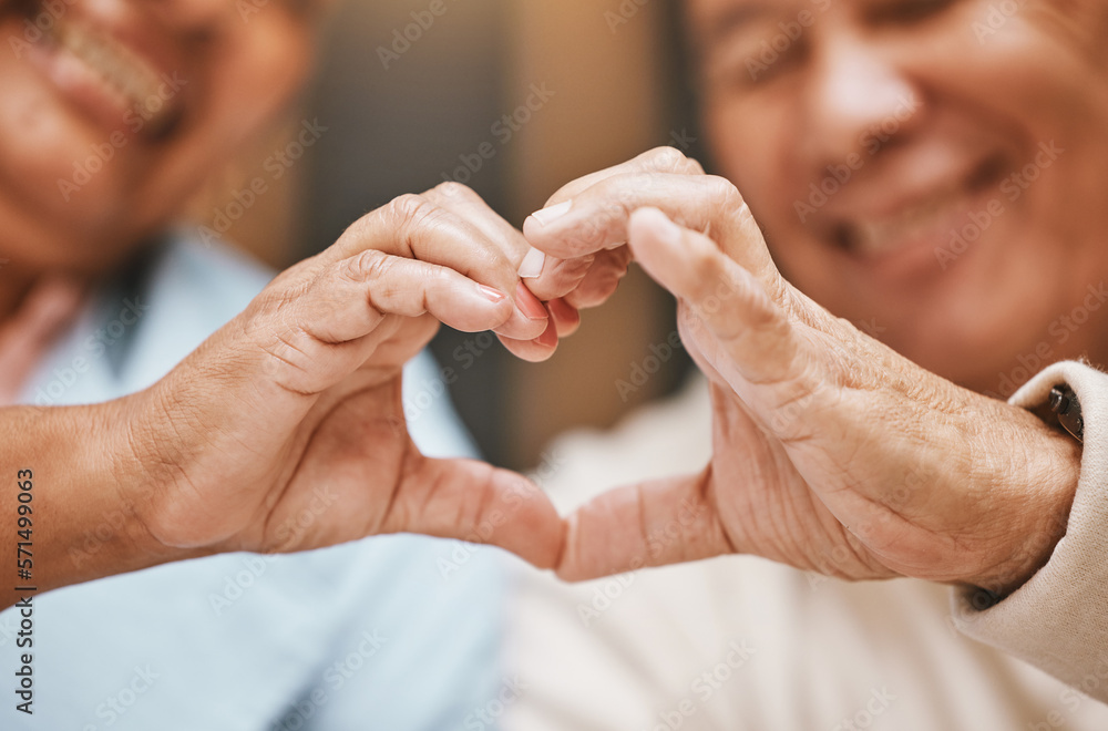 Fototapeta premium Love, heart hands or happy old couple with support, trust or hope in a marriage commitment at home. Romance, valentines day or senior man smiles with an elderly woman relaxing on anniversary