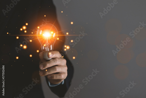 businessman holding a light bulb Digital technology. idea creative	