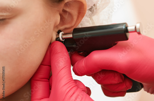 little girl during an ear piercing photo