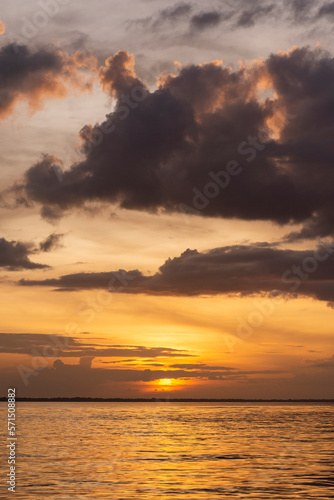 Beautiful view to orange sunset clouds and river in the Amazon Forest