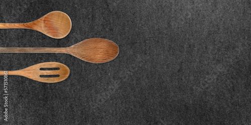 Topview of Set Cooking Wooden Utensils on Dark Background photo