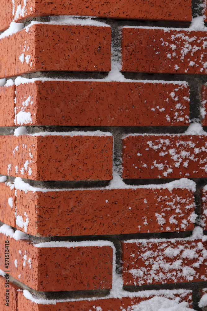 Obraz premium Brick partially covered with fresh snow.