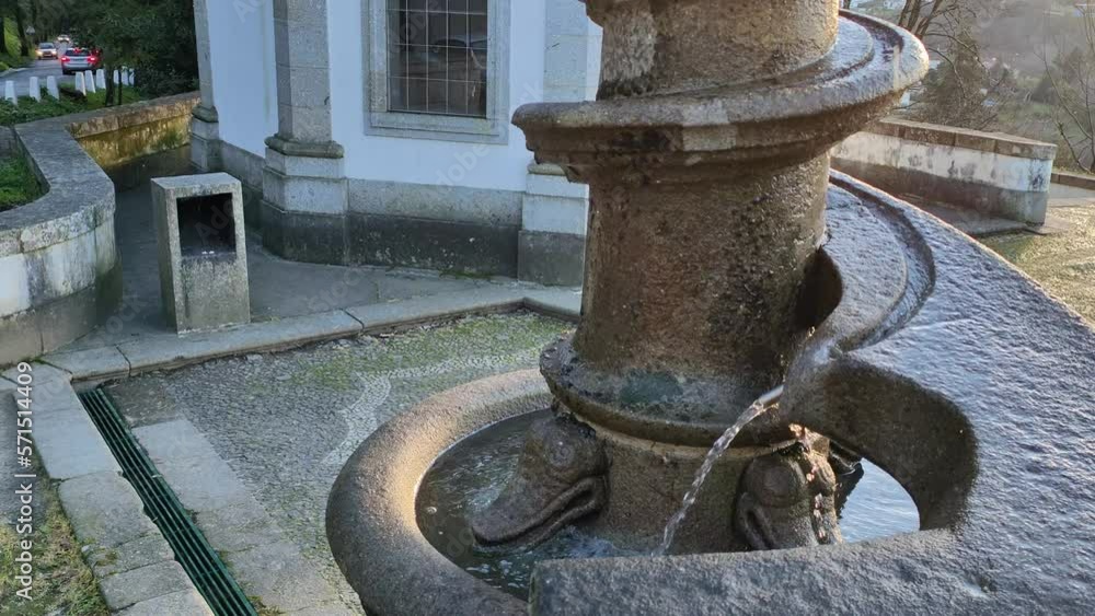 Static shot in detail of a spiral fountain of Bom Xesus of Braga, Portugal, with chapel to its right representing a passage of the life of jesus christ, in the background the city of Braga. Static shot in detail of a spiral fountain of Bom Xesus of Braga, Portugal, with chapel to its right representing a passage of the life of jesus christ, in the background the city of Braga.