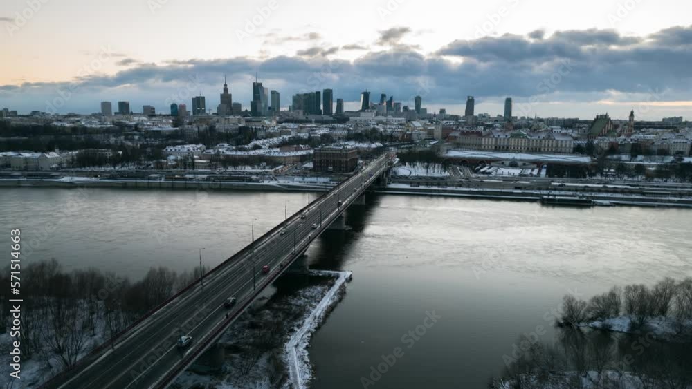 Cars driving over the Śląsko-Dąbrowski Bridge over the fast streaming Vistula River with a view on the modern skyscrapers in Warsaw. Drone hyperlapse Cars driving over the Śląsko-Dąbrowski Bridge over the fast streaming Vistula River with a view on the modern skyscrapers in Warsaw. Drone hyperlapse