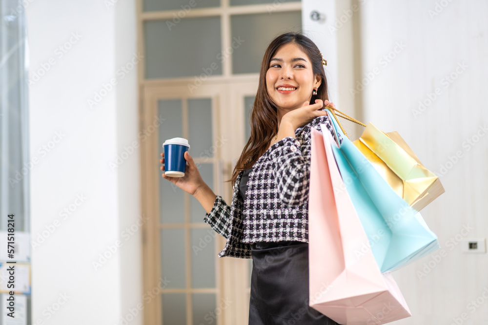 Portrait of smiling beauty asian fashion happy woman relax and enjoy shopping time summer sale walk and holding shopping colorful bag to buy something purchases use smartphone at store Portrait of smiling beauty asian fashion happy woman relax and enjoy shopping time summer sale walk and holding shopping colorful bag to buy something purchases use smartphone at store