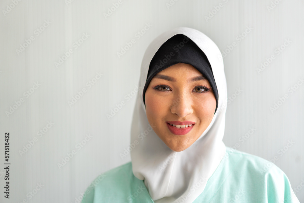 Beautiful happy confident asian muslim businesswoman smart looking at camara on office workplace desk.Young muslim creative coworkers business people working and planning Beautiful happy confident asian muslim businesswoman smart looking at camara on office workplace desk.Young muslim creative coworkers business people working and planning