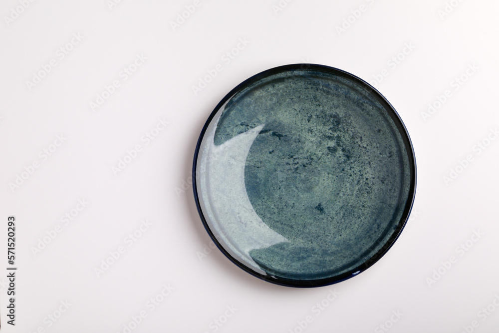 Plate on the white background. Blue plate. Plate on the white background. Blue plate.