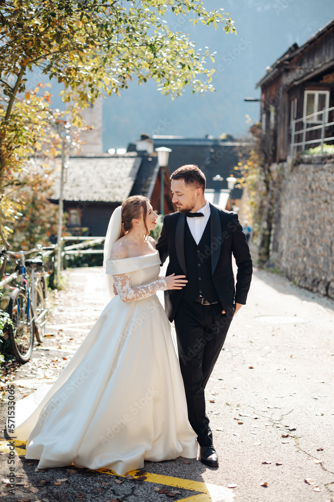 Loving bride and groom looking at each other and walking through the street Loving bride and groom looking at each other and walking through the street