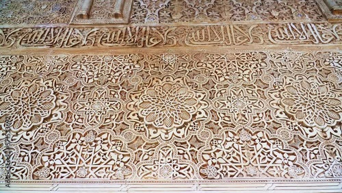 Wall carved with islamic motifs, muslim istoric art. Alhambra, Granada. photo