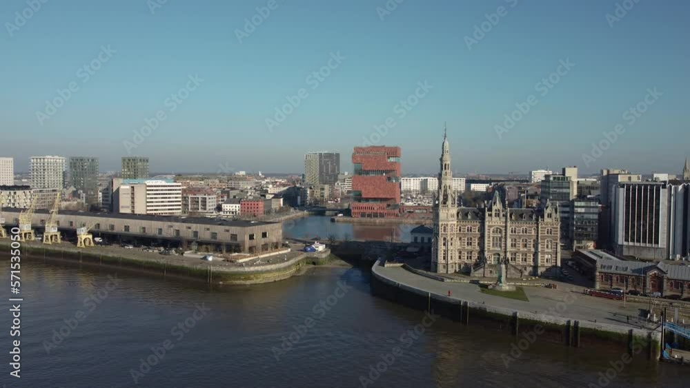 Cinematic Establishing 4k drone shot of the loodsgebouw (the Antwerp pilot building) in the Belgian city of Antwerpen and the MAS museum in the backgound over the river Scheldt (Schelde) Cinematic Establishing 4k drone shot of the loodsgebouw (the Antwerp pilot building) in the Belgian city of Antwerpen and the MAS museum in the backgound over the river Scheldt (Schelde)