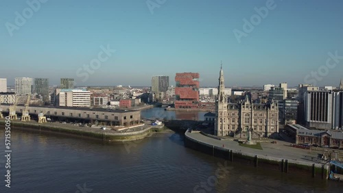 Cinematic Establishing 4k drone shot of the loodsgebouw (the Antwerp pilot building) in the Belgian city of Antwerpen and the MAS museum in the backgound over the river Scheldt (Schelde) photo