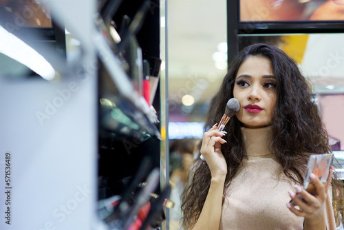 A girl in a cosmetics store. Fashion and beauty industry