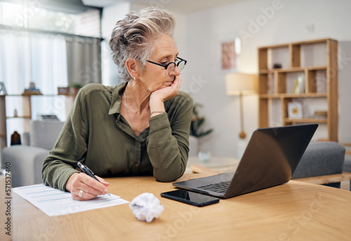 Focus, planning and senior woman on laptop writing, work from home budget or financial strategy. Person thinking, reading debt and pension document or insurance paperwork, taxes or finance investment