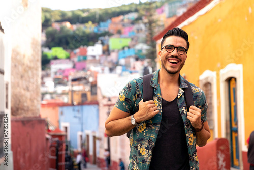 Mexican man traveling in Guanajuato. Student exploring a colorful city. 