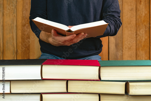 man holding and reading a book