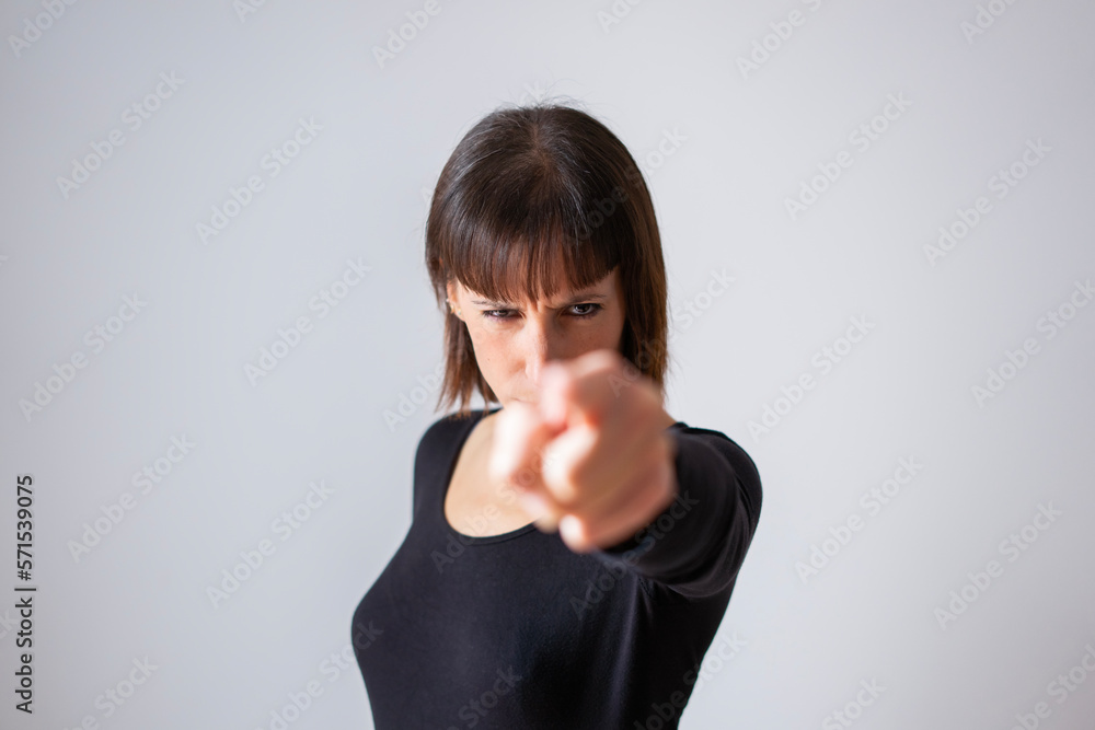Portrait of a girl on white background. Brown short hair girl. angry girl pointing finger Portrait of a girl on white background. Brown short hair girl. angry girl pointing finger