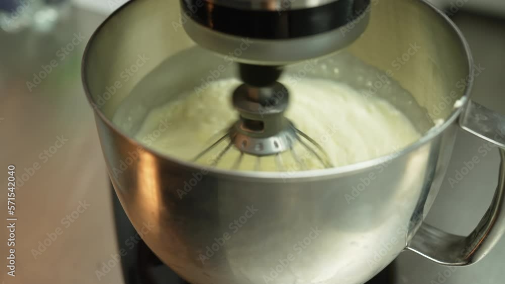 Close up shot of food processor mixing pastry in a metal bowl. Blurred kitchen counter in the background. High quality 4k footage Close up shot of food processor mixing pastry in a metal bowl. Blurred kitchen counter in the background. High quality 4k footage
