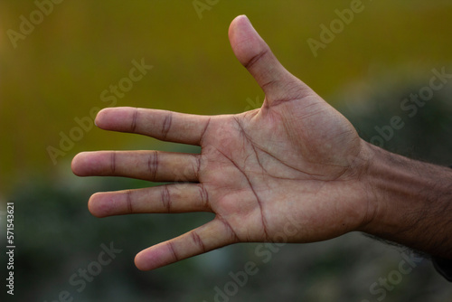 This is a human hand and the background is blurred © Rokonuzzamnan