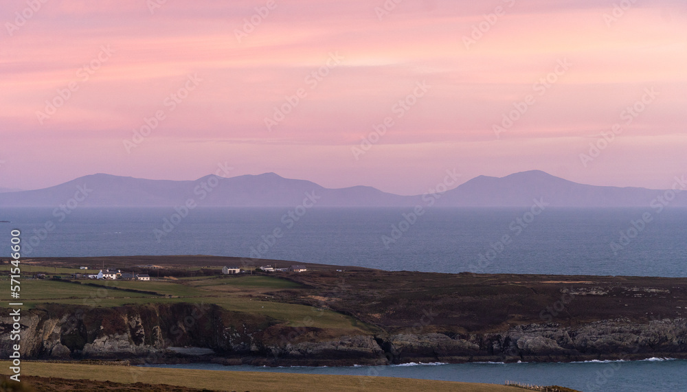 Vibrant Sunset over Anglesey looking towards the mountains of Snowdonia. 