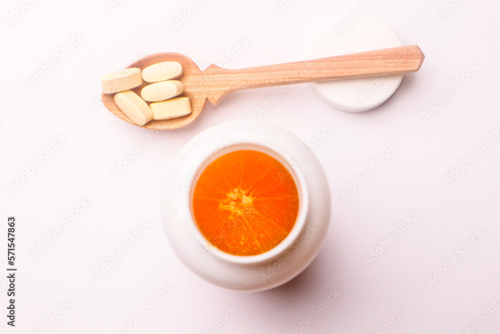 Vitamins pills in a spoon on a white background Vitamins pills in a spoon on a white background
