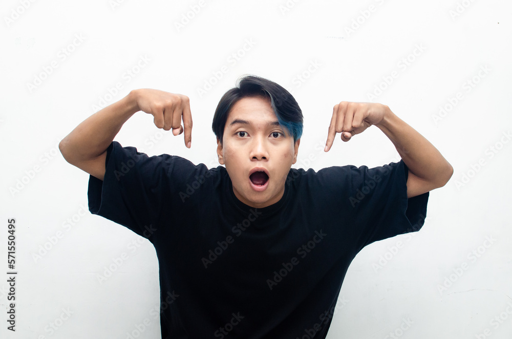 A cheerful, ecstatic Asian man wears a casual black t-shirt, pointing to copy space and presenting and displaying goods. billboard model advertisment concept. A man with a wow expression promoting A cheerful, ecstatic Asian man wears a casual black t-shirt, pointing to copy space and presenting and displaying goods. billboard model advertisment concept. A man with a wow expression promoting