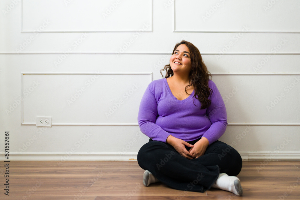 Pensive woman looking up thinking and smiling Pensive woman looking up thinking and smiling