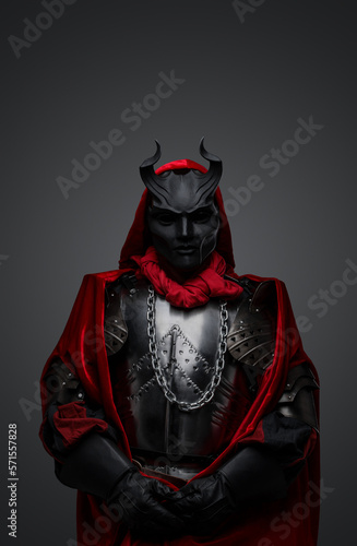 Fototapeta Naklejka Na Ścianę i Meble -  Portrait of dark member of mysterious cult dressed in red robe and black mask.