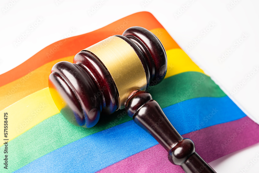 Gavel for judge lawyer on rainbow flag, symbol of LGBT pride month celebrate annual in June social of gay, lesbian, bisexual, transgender, human rights.