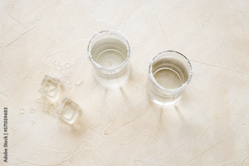 Glasses of tequila with lime and salt. Strong alcohol background Glasses of tequila with lime and salt. Strong alcohol background