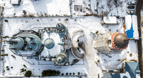 a beautiful old baroque church with a bell tower in the village of Bykovo near Moscow in winter shot from a drone