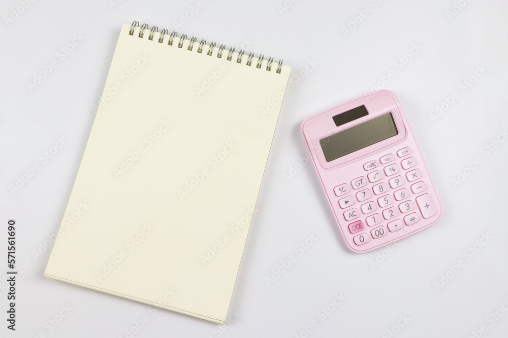 flat lay of pink calculator with blank page opened notebook. business and education concept. flat lay of pink calculator with blank page opened notebook. business and education concept.