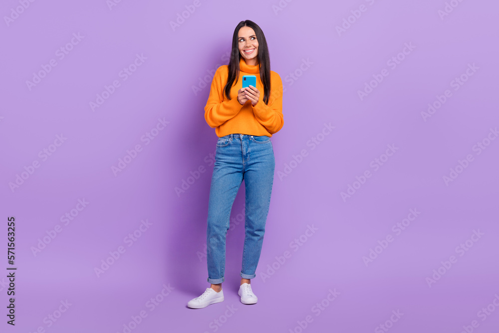 Full length photo of lady influencer use smart gadget look up empty space web shopping isolated violet color background Full length photo of lady influencer use smart gadget look up empty space web shopping isolated violet color background