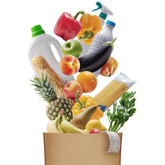 Assorted groceries falling in a paper bag