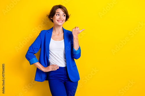 Photo of professional hr manager recruiter wear blue jacket looking opening new it company demonstrate brand isolated on yellow color background