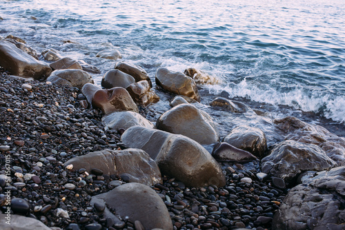  Seashore with pebbles and stones in the evening at sunset