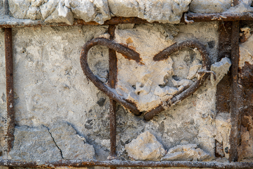 Concrete background for Valentine's Day design. Decorative heart made of rusty wire. Valentine's Day concept. The 14th of February Concrete background for Valentine's Day design. Decorative heart made of rusty wire. Valentine's Day concept. The 14th of February