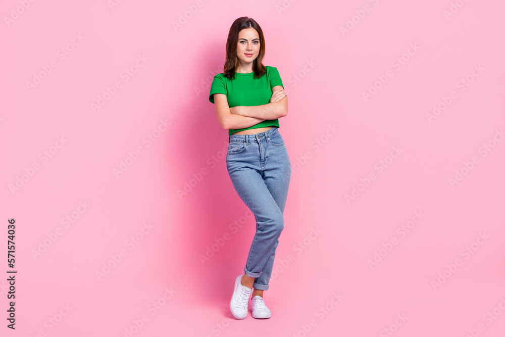 Full length photo of pretty confident girl wear green crop top arms folded isolated pink color background Full length photo of pretty confident girl wear green crop top arms folded isolated pink color background