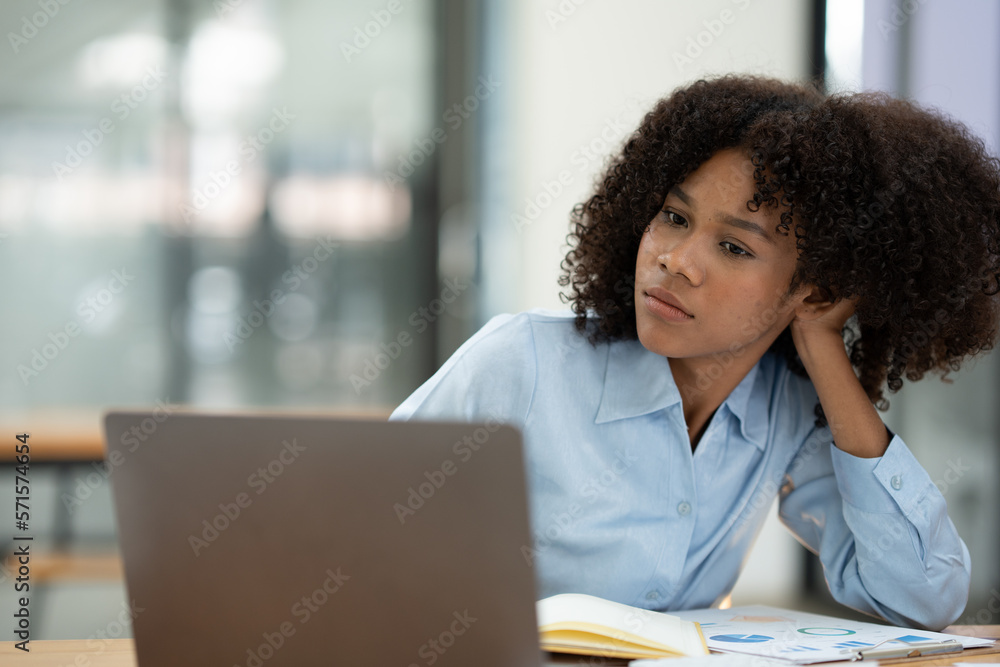 Positive successful african american woman, manager, CEO, sitting in the office at a laptop talking video call with client or employee discussing business strategy and ideas analyzed together Positive successful african american woman, manager, CEO, sitting in the office at a laptop talking video call with client or employee discussing business strategy and ideas analyzed together