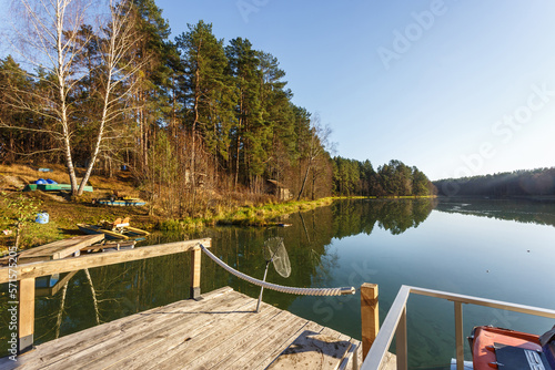 wooden house with piers on the lake. a place to relax from the hustle and bustle of the city
