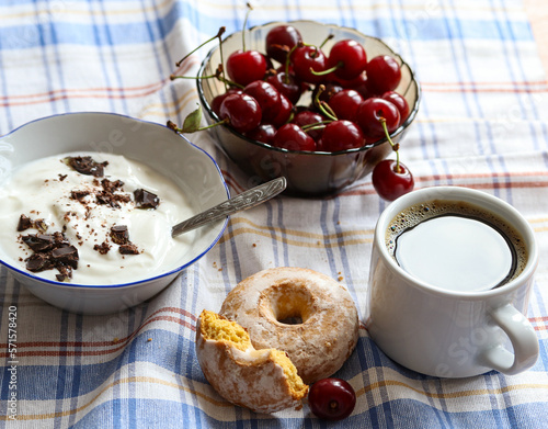 yogurt with chocolate in a bowl and ripe cherries