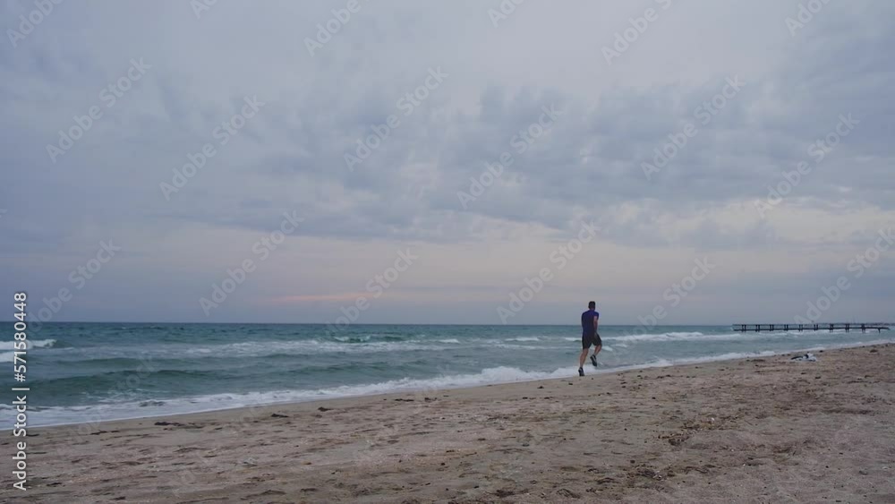 slow motion man athlete running in beach slow motion man athlete running in beach