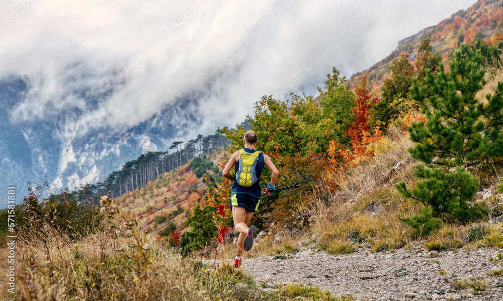 athlete runner with trekking poles run autumn mountain race athlete runner with trekking poles run autumn mountain race