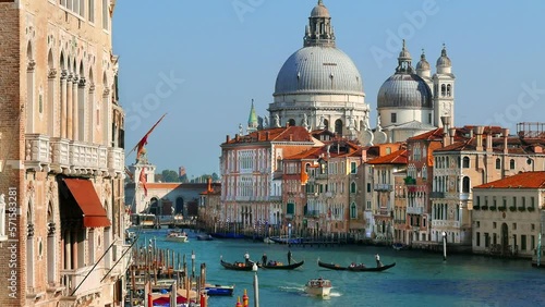 Grand Canal in Venice with Gondolas crossing the water and Cathedral Santa Maria della Salute.
