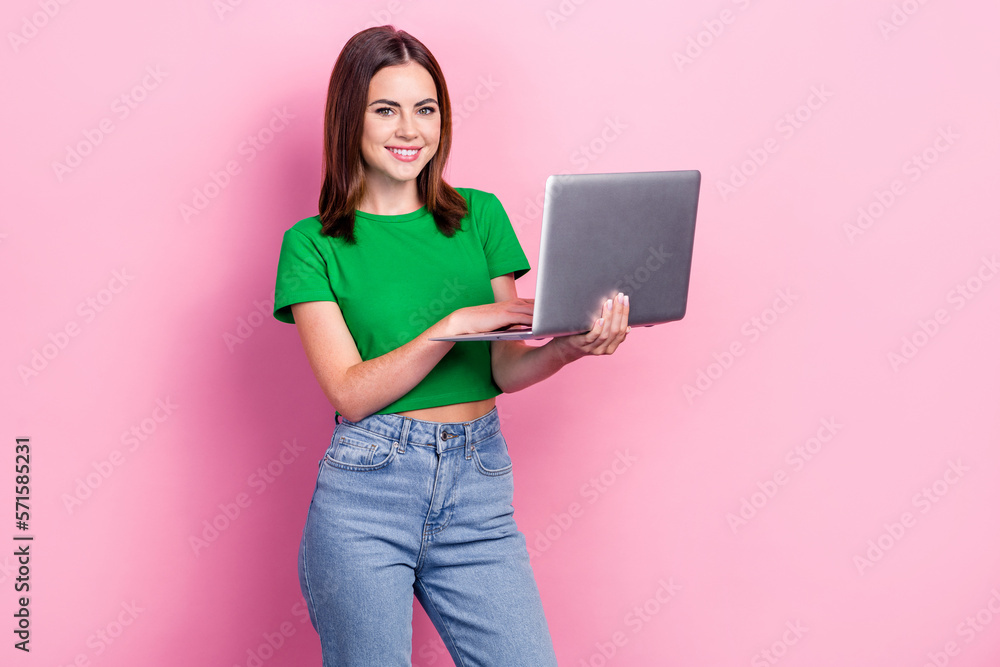 Photo of cheerful pretty person hold use wireless netbook write email isolated on pink color background Photo of cheerful pretty person hold use wireless netbook write email isolated on pink color background
