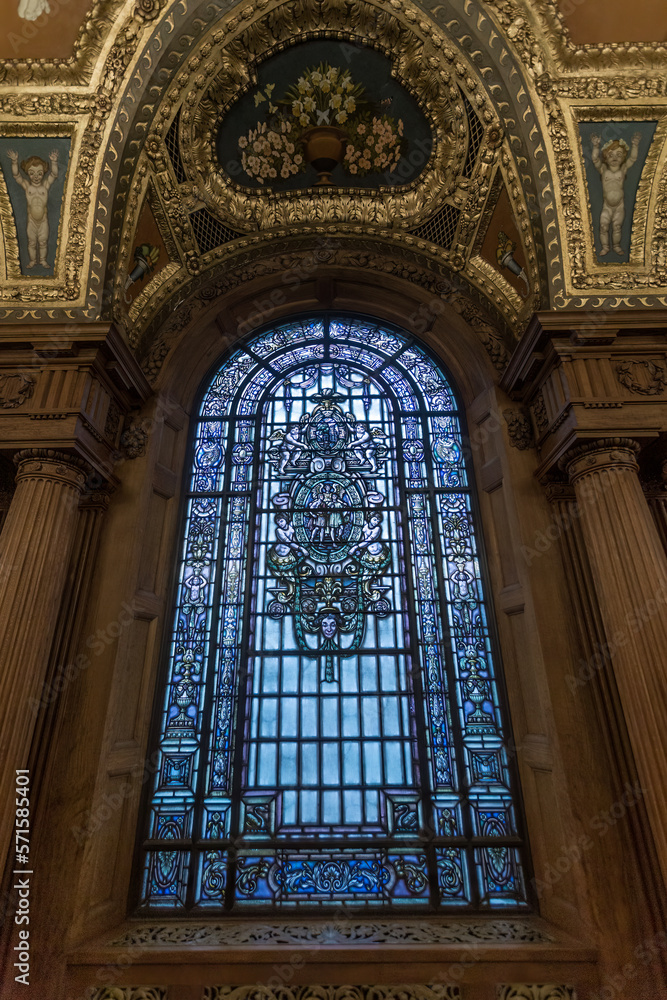 Tall and elegant stainded glass window in elaborate and decorative building