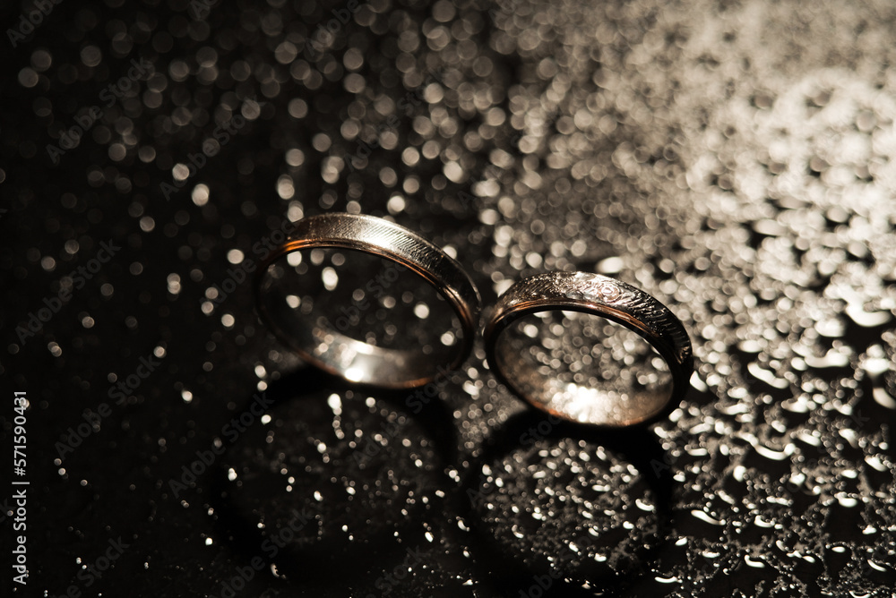 Detailed gold wedding ring on beautiful raindrops background Detailed gold wedding ring on beautiful raindrops background